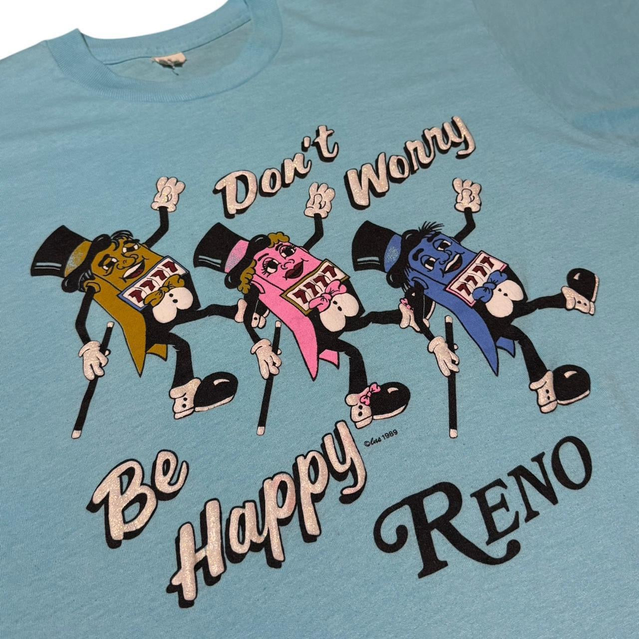 1989 Baby Blue Reno Nevada Don’t Worry, Be Happy Gambling Slots Machine Souvenir Tee