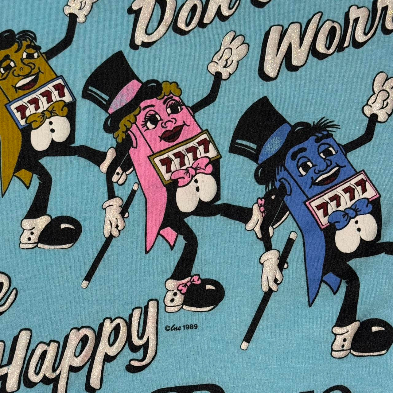 1989 Baby Blue Reno Nevada Don’t Worry, Be Happy Gambling Slots Machine Souvenir Tee